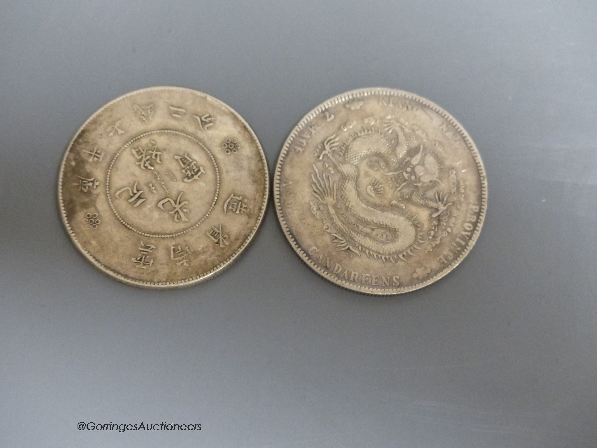 A South East Asian terracotta Buddha's head and two Chinese coins